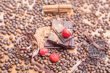 For holiday of chocolate day - wooden table background decorated a lot of coffee beans, chocolate...