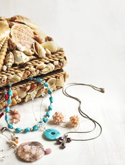 A collection of jewelry in jewelry box decorated with seashells