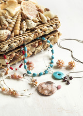 Collection of jewelry in jewelry box decorated with seashells