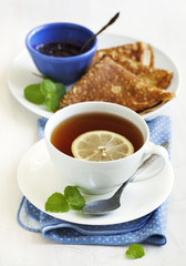 Cup of Lemon Tea and crepes with jam
