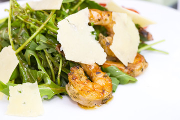 shrimp salad and greens on a white background