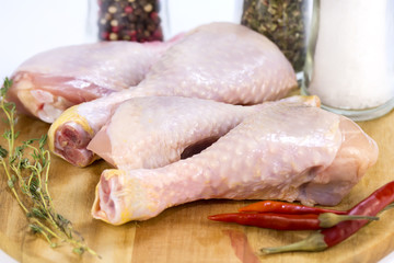 raw chicken legs on wooden board for preparation