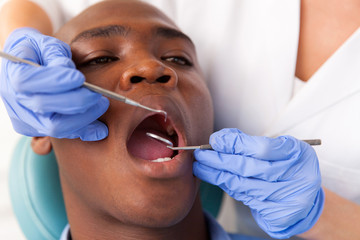 african male patient getting dental treatment