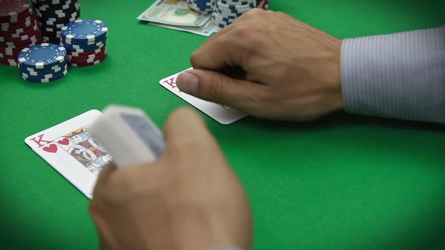 poker dealer distributes cards on the green table