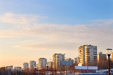 Fototapeta na wymiar Apartment buildings in residential quarter of city at sunset