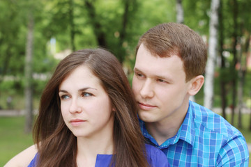 Fototapeta premium Young beautiful amn and woman looks away and dream in summer par