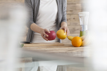 Women are taking to hand the fruit in the kitchen