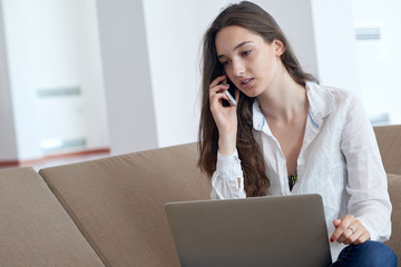 relaxed young woman at home working on laptop computer