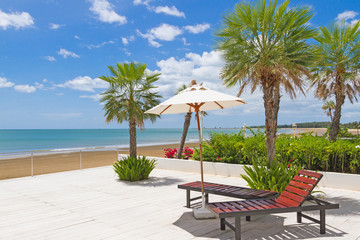 Sunbeds beside swimming pool with sea view