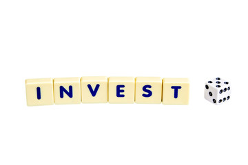 Financial concept,scrabble  invest text with dice