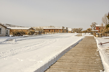 Fototapeta na wymiar Deserted Main Street in a ghost town in winter