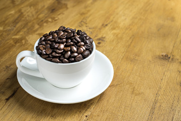 Cup full of coffee beans on the table