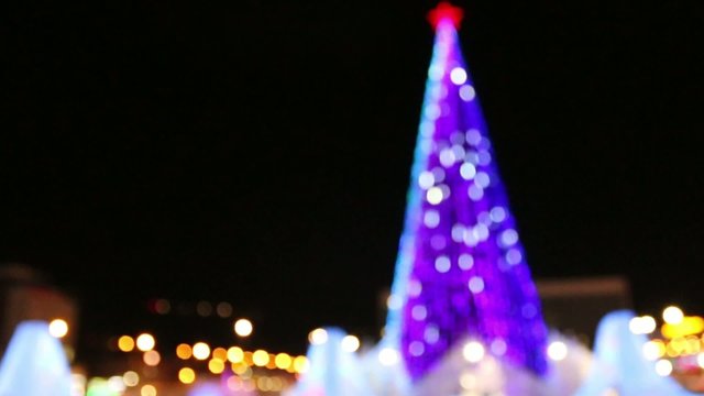 Christmas tree with illumination outdoor at winter night out of focus

