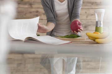 Fototapeta premium Women are cooking while watching the recipe book