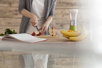 Women are cut the apple with a knife.