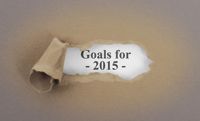 Text appearing behind torn brown envelop