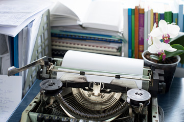 Vintage typewriter on a table with books