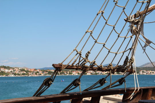 Fototapeta Sails / Sails of a pirate ship on a background of blue sky.