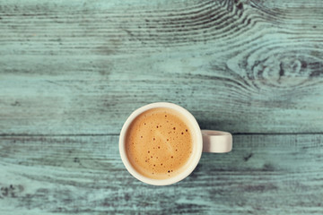 Cup of fresh aroma coffee on vintage wooden blue table