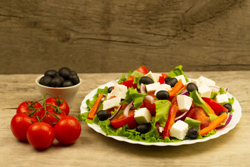 cooking summer Greek salad on wooden background