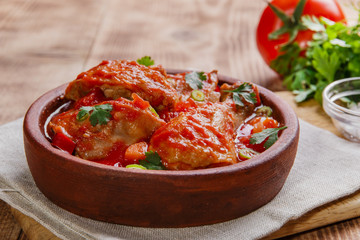 chicken in tomato sauce in a bowl chakhokhbili