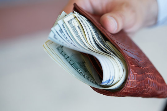 Man Holding A Purse With Money Closeup