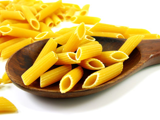 italian penne rigate macaroni pasta raw food background or