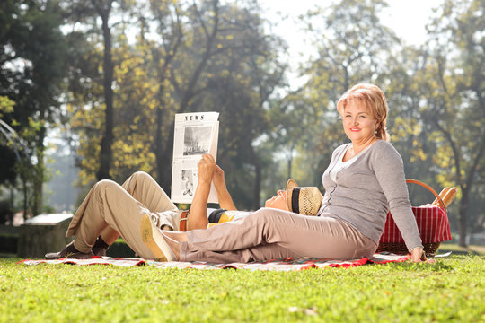 Mature woman posing in park with her husband