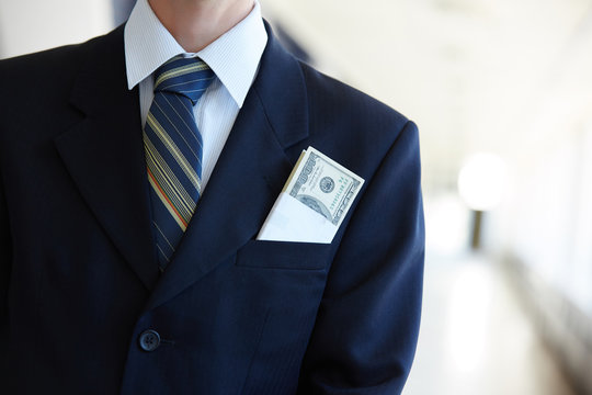 From His Pocket A Businessman Sticking Out Of Money