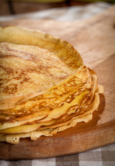 Stack of pancakes on a wooden board
