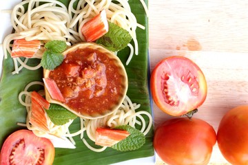 Pasta spaghetti with crab sticks and sauce.