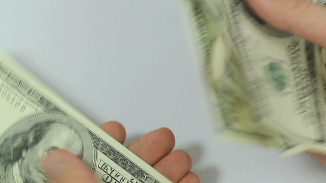 Counting money, seamless loop video of male hands counting a lot of one hundred dollar bills