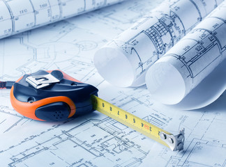 Tape measure over a construction plan drawing