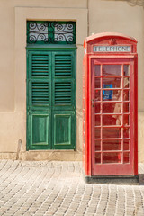 Fototapeta premium Traditional British phone box in Maltese village of Marsaxlokk