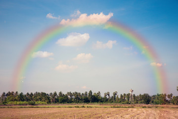 Countryside of local Thailand with rainbow and sky.