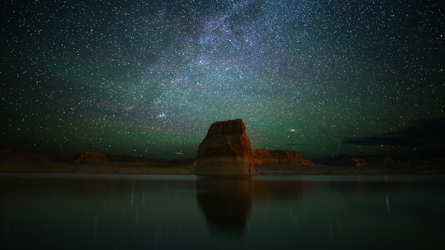  Astrophotography time lapse footage with zoom in motion of milky way galaxy over lone rock in Lake Powell, Glen Canyon National Recreation Area, Utah