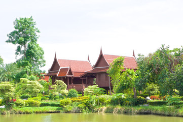 Fototapeta na wymiar Traditional Thai house in garden beside river