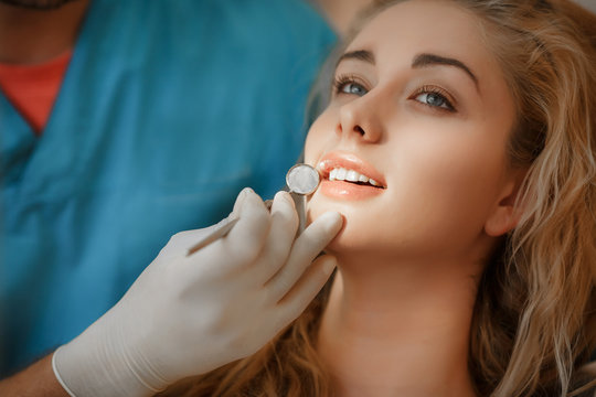 Dentist and female pacient at dental clinic tooth care