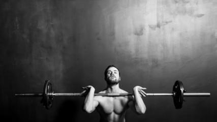 Bodybuilding, Young Athletic Strong Man Weightlifting , Black and White in studio - 85873297