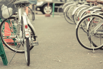 Fototapeta na wymiar Bicycle parking in Japan. Vintage filter