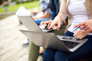 close up of students or teenagers with laptop