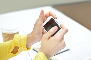 close up of female hands with smartphone at home