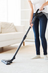 close up of woman with vacuum cleaner at home
