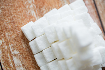 close up of white sugar pyramid on wooden table
