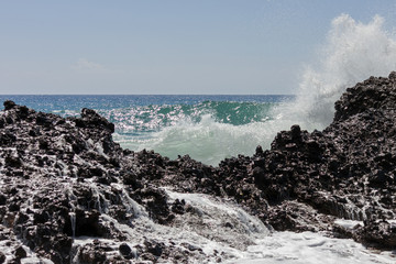 A big wave breaks against the rocks on falasarna beach, Crete.
