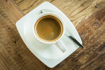 Coffee cup and laptop in coffee shop
