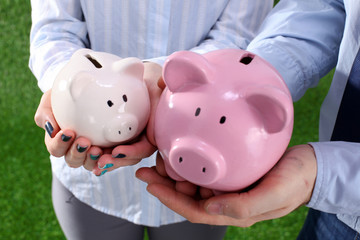 Piggy Bank in hands of a family