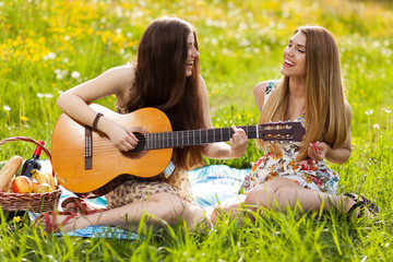 Two beautiful young women on a picnic