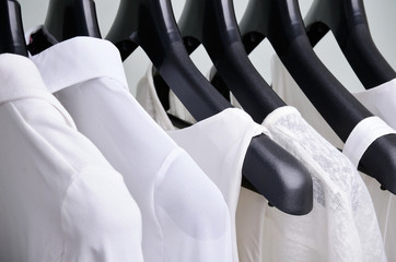 white womens clothing hanging close up horizontal