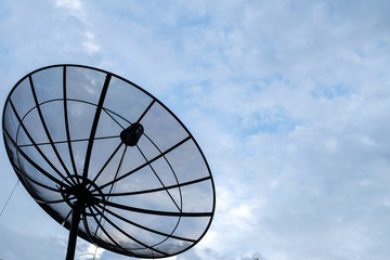 Satellite dish on cloudy sky backgound